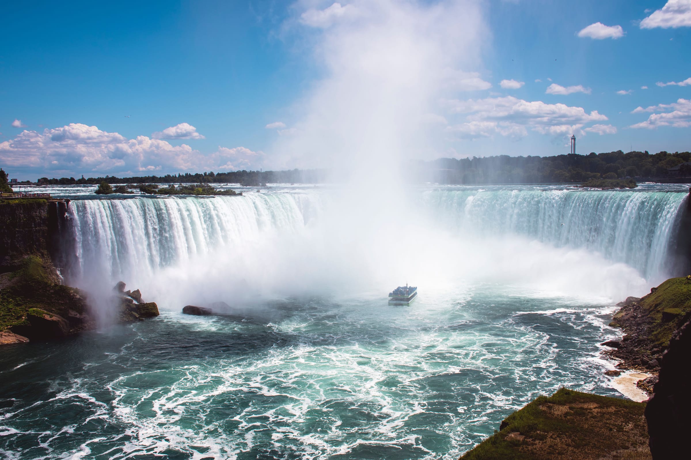 A tour boat in the mist below the thundering Horseshoe Falls at Niagara